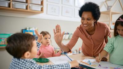 Teacher high fiving a student