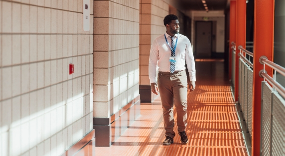 teacher walking in the school that he works at in Gateshead, North East England.