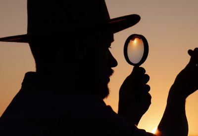 silhouette of a detective with magnifying glass