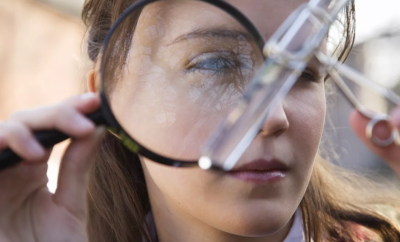 Girl using a magnifying glass