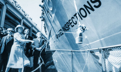 People by the side of a boat that says NO INSPECTIONS