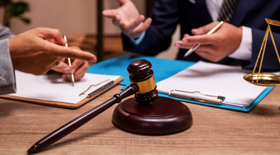 Gavel on a desk next to various files and papers