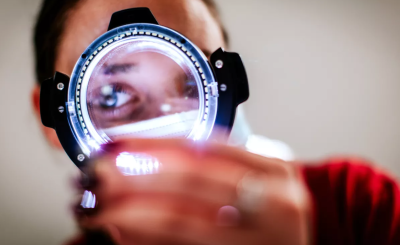 Person behind a magnifying glass