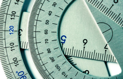 Close up of metal protractors and other maths equipment