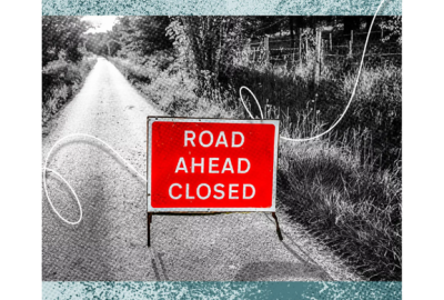 road with "road ahead closed" sign