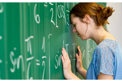 Woman with head against a chalkboard